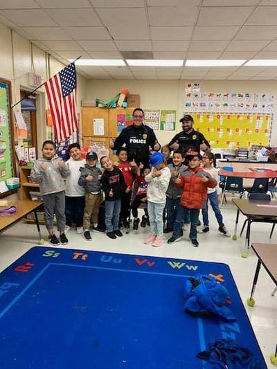 Officer Chavez and Officer Elliott Reading to Students